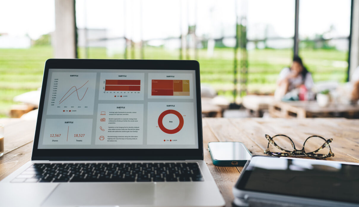 laptop with diagrams and gadgets on table in cafe 2026 01 09 07 32 37 utc scaled