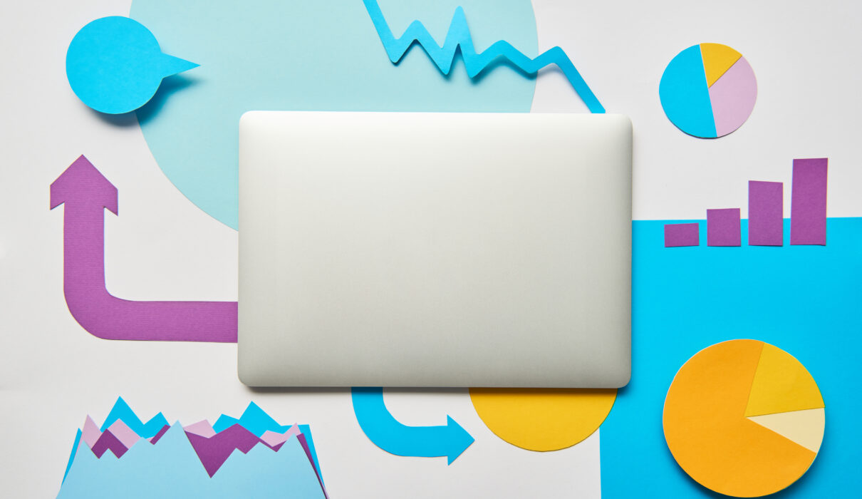 top view of closed laptop and paper charts and gra 2026 03 13 01 14 18 utc scaled