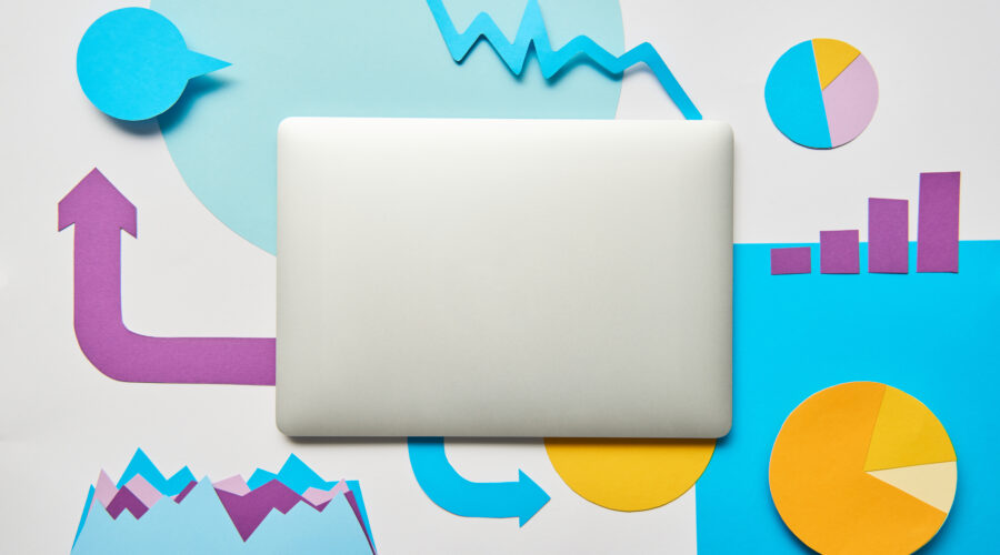 top view of closed laptop and paper charts and gra 2026 03 13 01 14 18 utc scaled